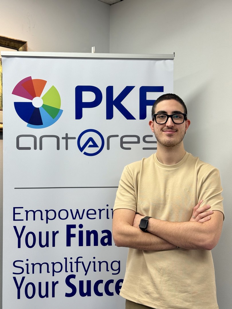 Standing beside a PKF Antares banner